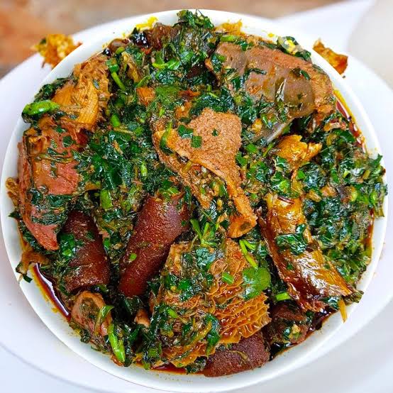 Bowl of Afang soup with leafy waterleaf greens and assorted meat